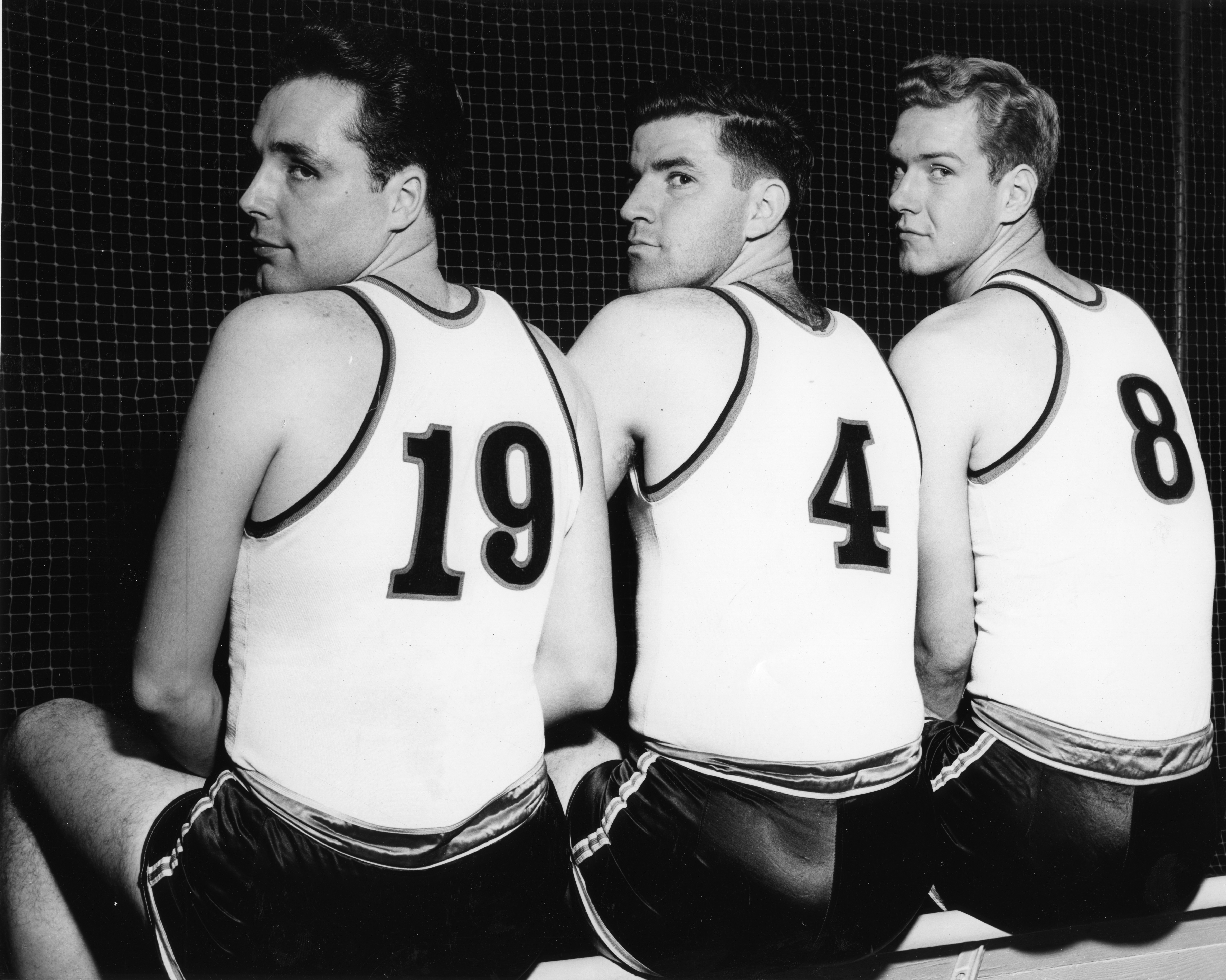 Three basketball players look over their shoulders, 1948 Three basketball players look over their shoulders, 1948